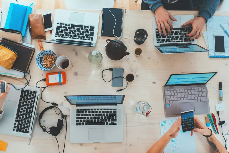 Several people working together on laptops at a table