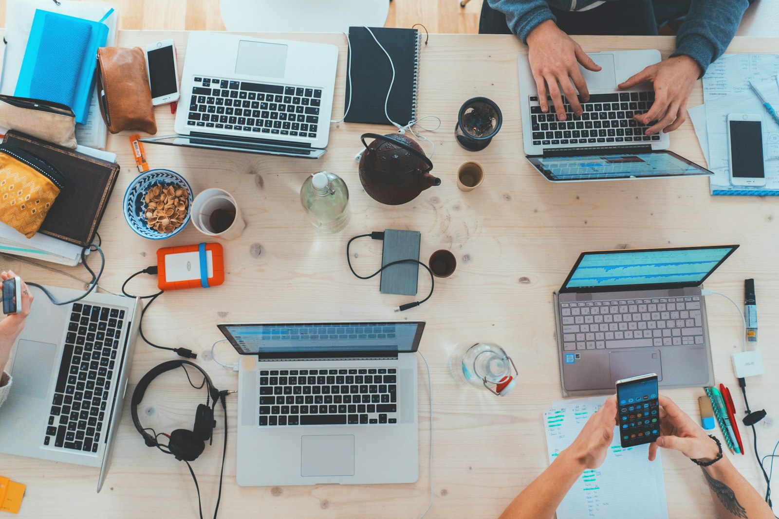 Several people working together on laptops at a table