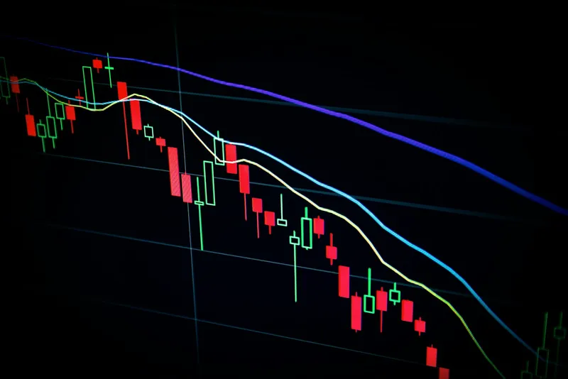 Laptop screen filled with financial candlestick charts