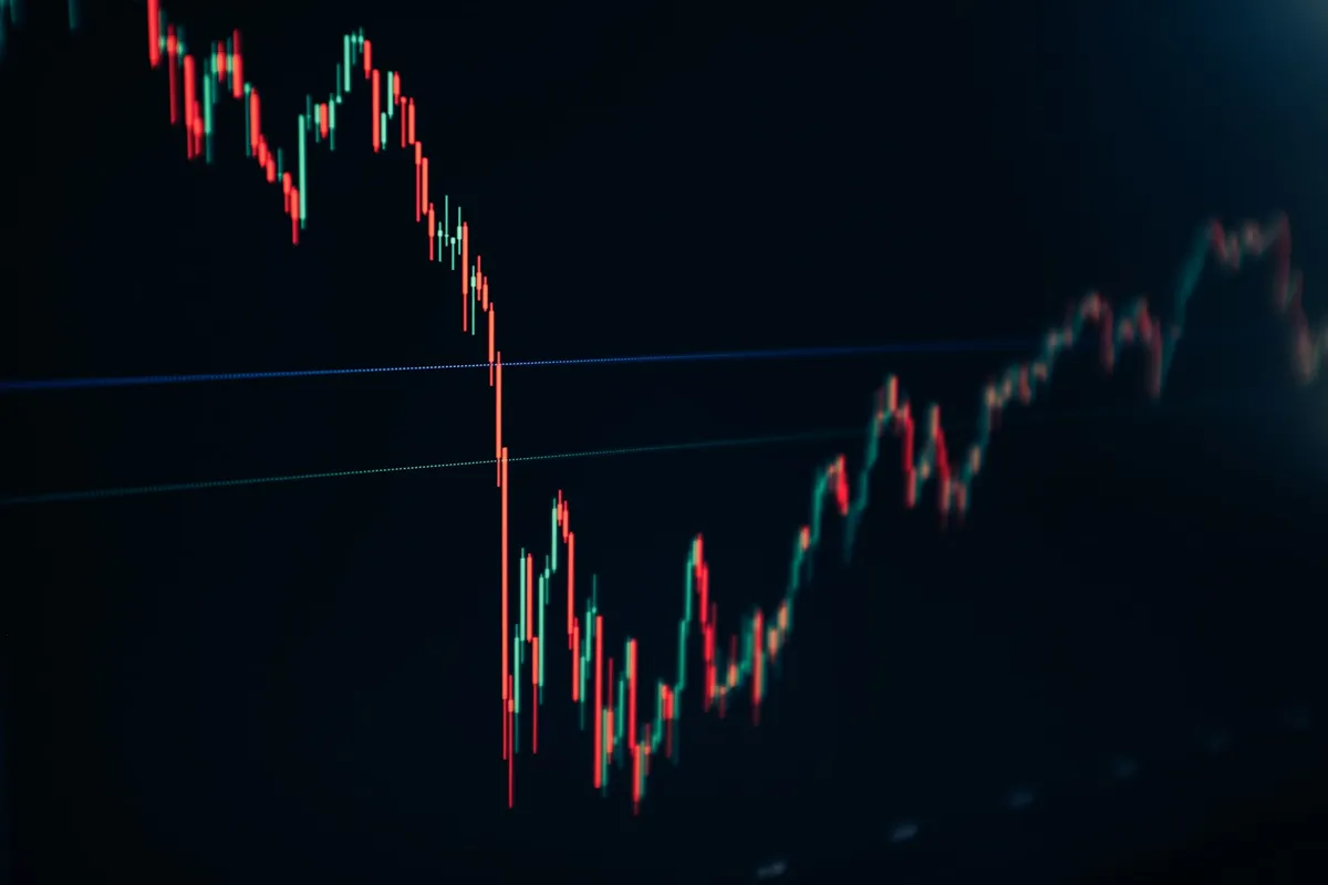A candlestick price chart on a dark screen