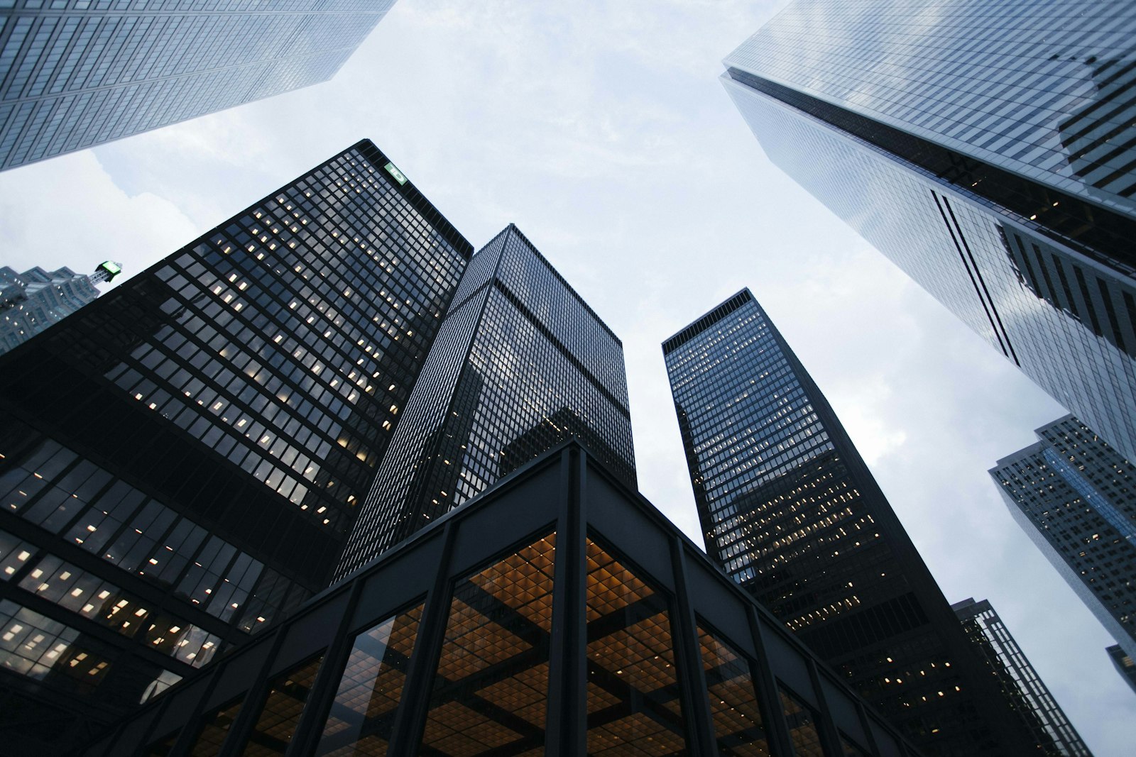 Looking up at glass skyscrapers in a financial district