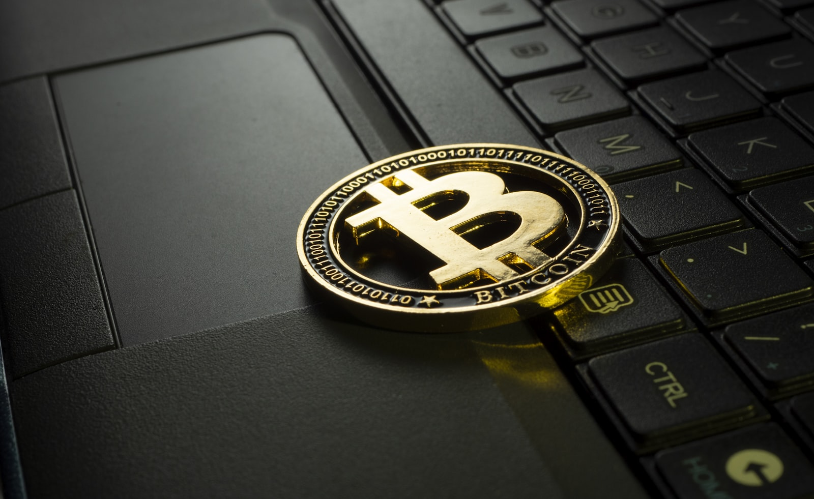 Close-up of a physical bitcoin coin showing the Bitcoin symbol
